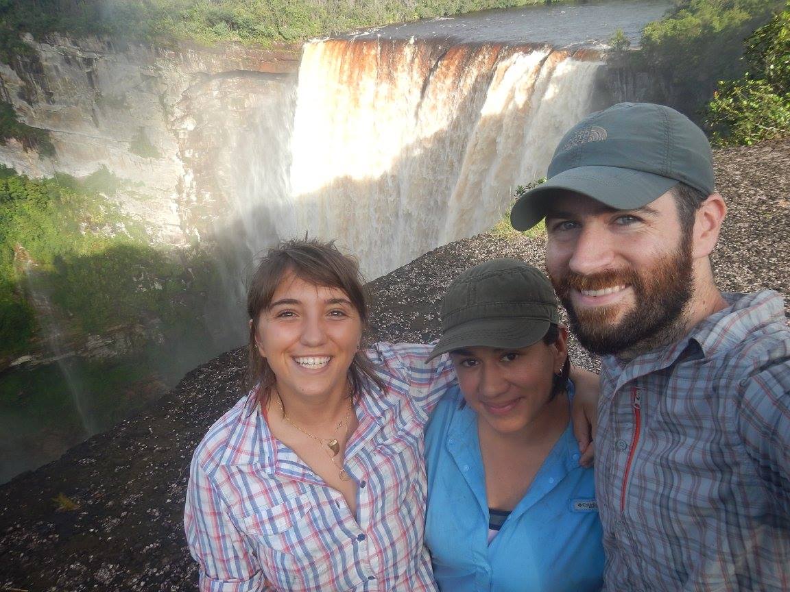 Dr. Johana Goyes Vallejos with her colleagues, Dr. Chloé Fouilloux and Dr. James Tumulty, taking a selfie in front of a waterfall.